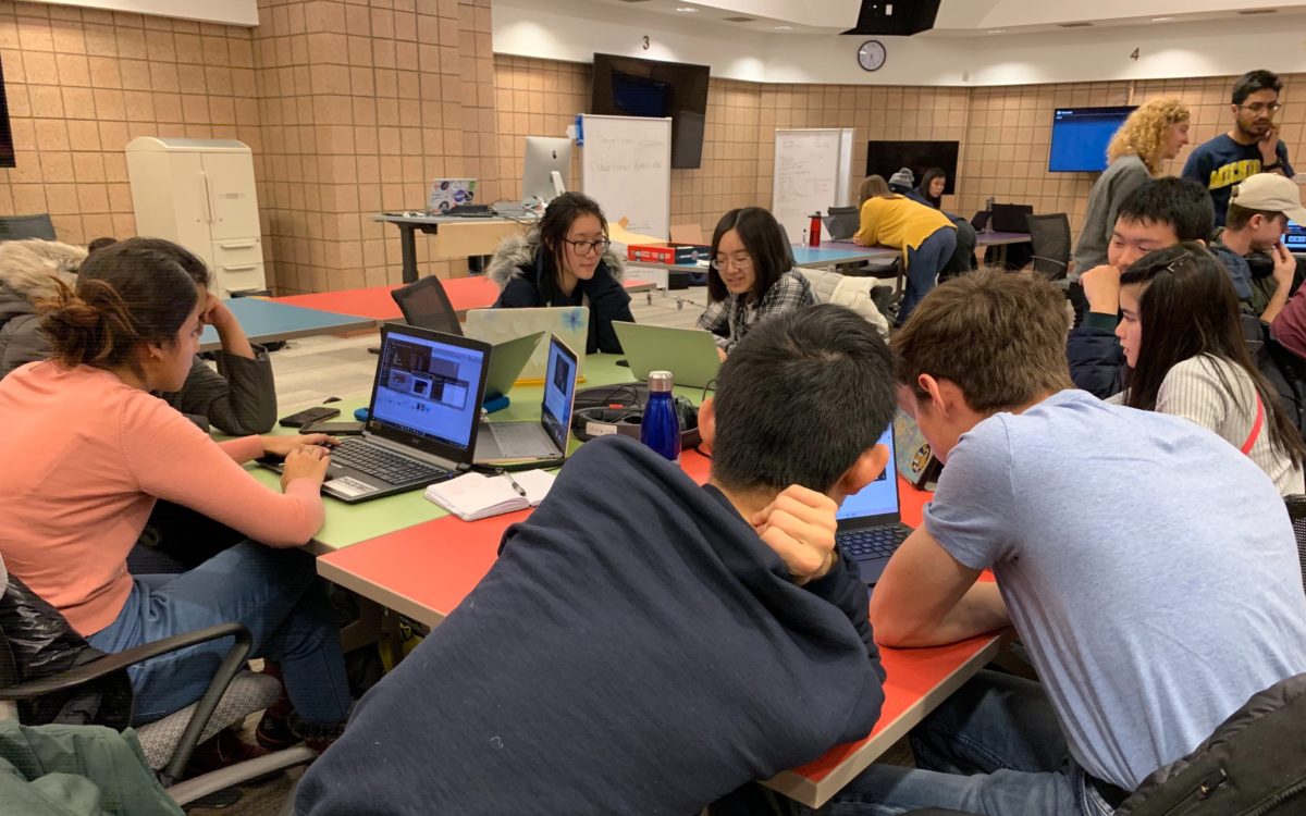 students collaborate in small groups in a flexible lab space