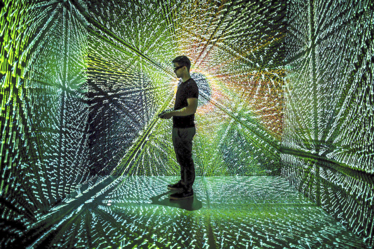 photo of Jeremy Young, MSE BSE Student, runs a cylinder combustion simulation in the MiDEN Michigan Immersive Digital Experience Nexus (MIDEN) in the Duderstadt Center