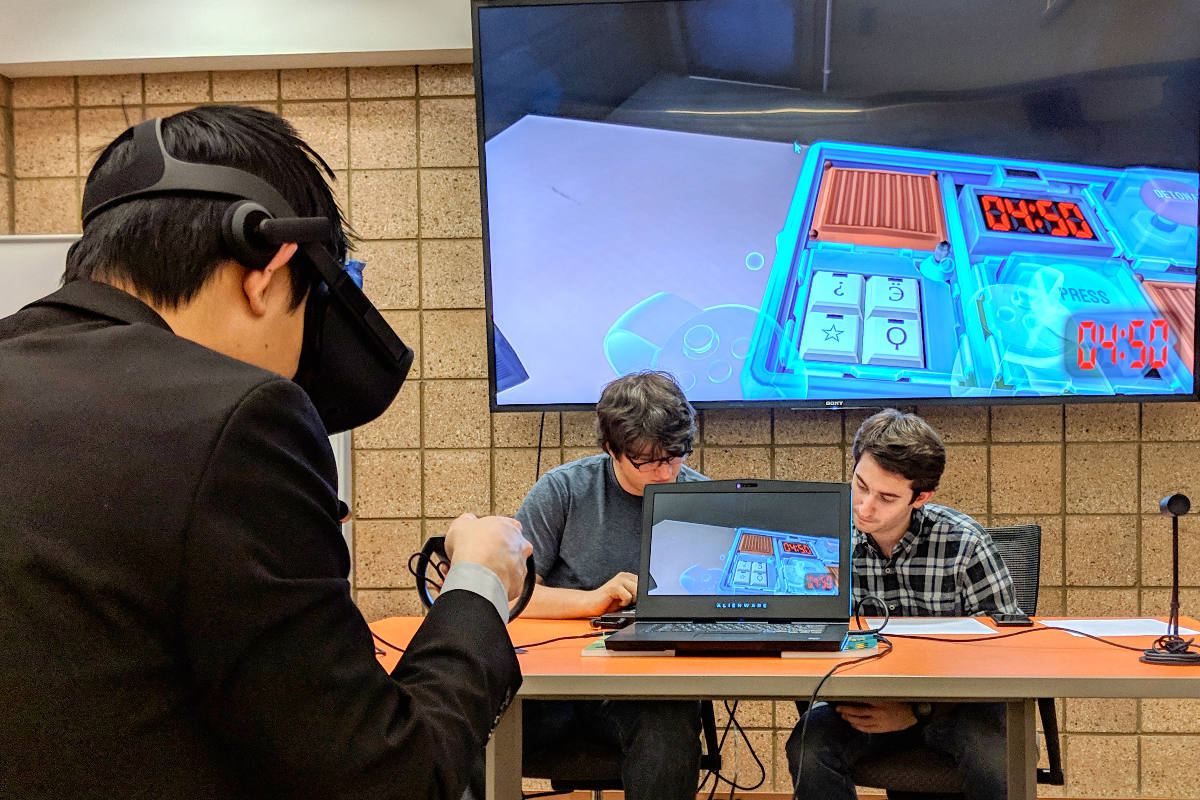 student playing a vr game displayed on big screen