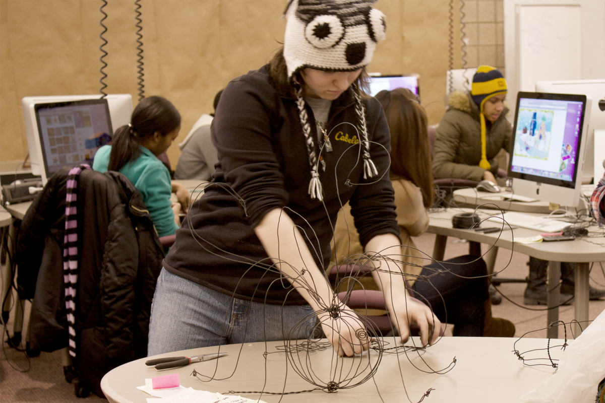 a photo of students working on with physical and digital design media in the Design Studio