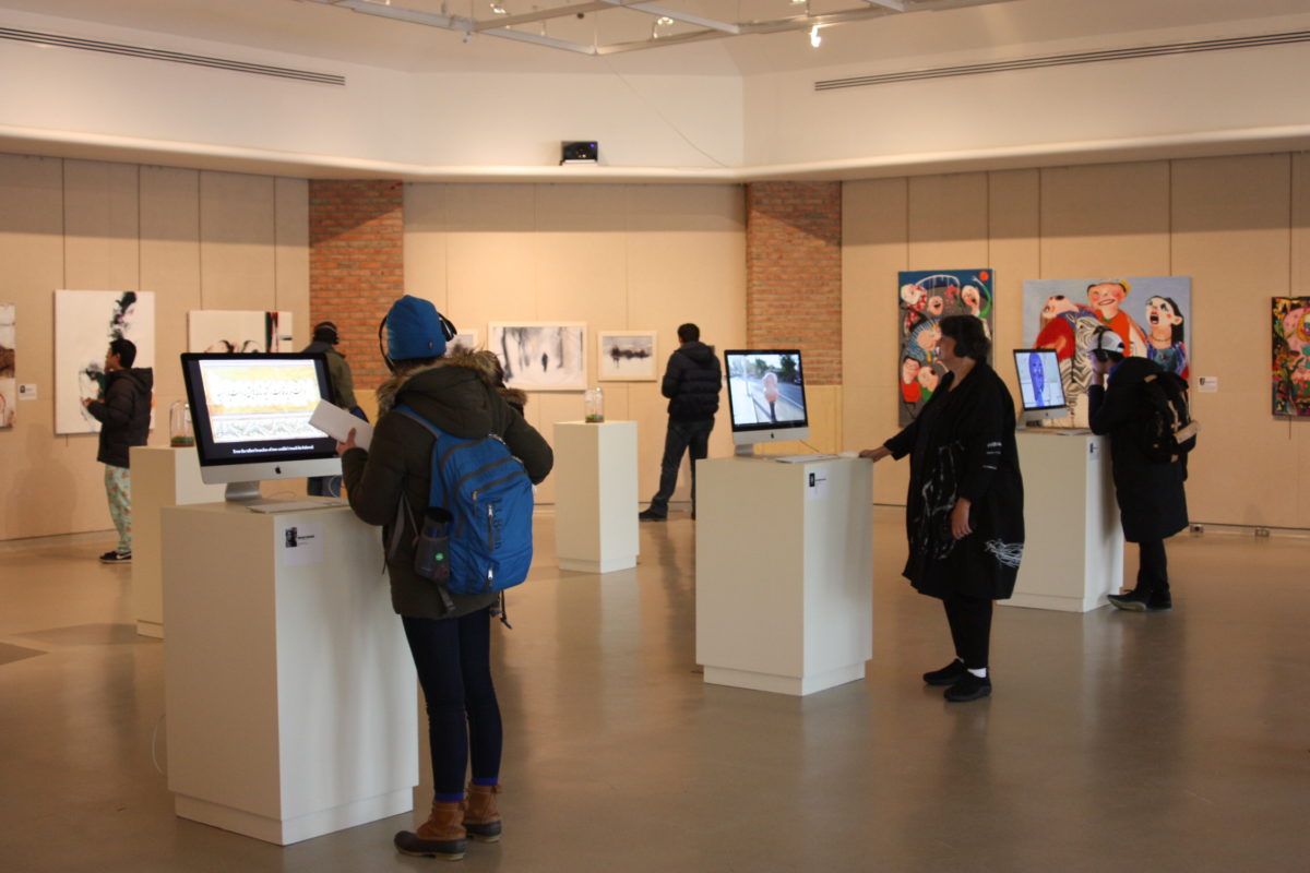 People admiring art on display in gallery
