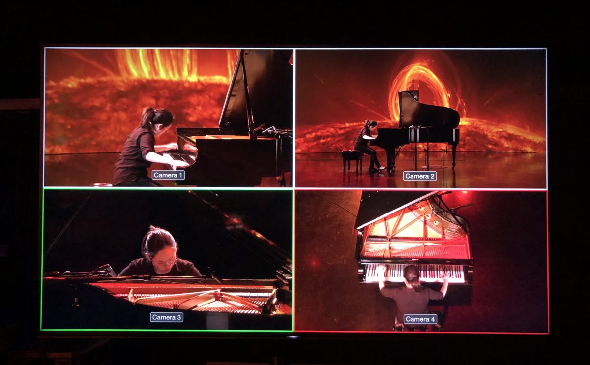 image of multiple studio monitors during the recording of Melissa Coppola's doctoral thesis composition "Lights on the Sky" performed in the Duderstadt Center Video Studio