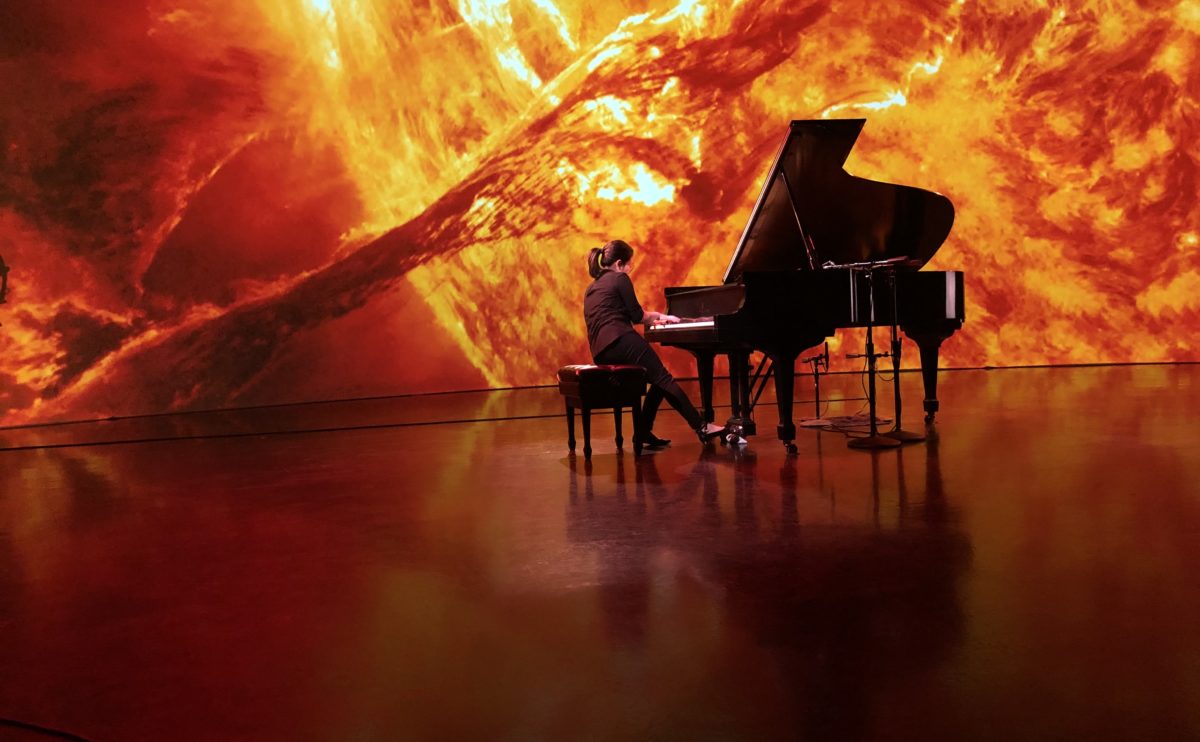 image of Melissa Coppola performing doctoral thesis composition “Lights in Sky”, a multimedia concert inspired by the cosmos