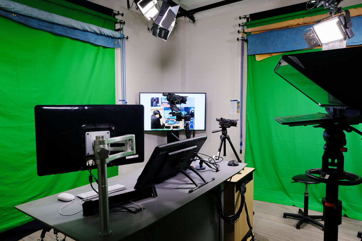 photo take in the Personal Studio showing the lectern and control console, teleprompter and multiple green screen backdrops