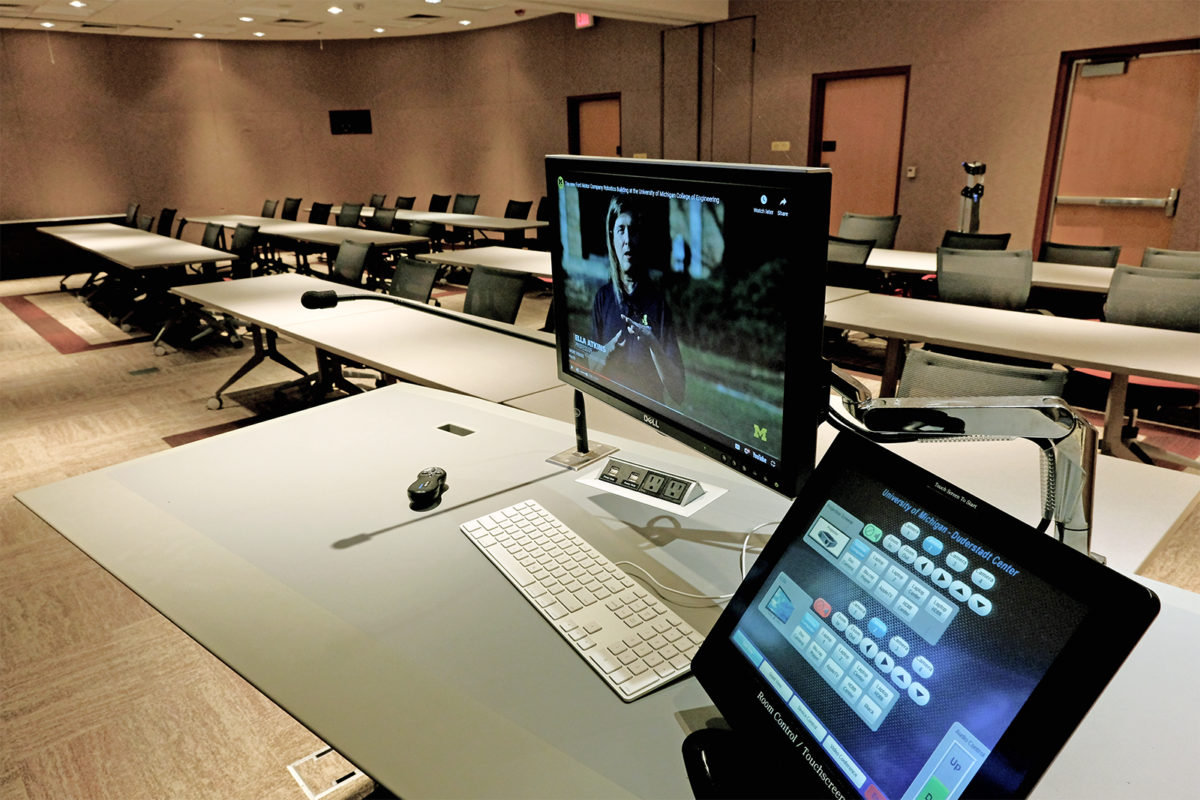 a photo taken in Presentation Room 1180 showing the lectern and media control console