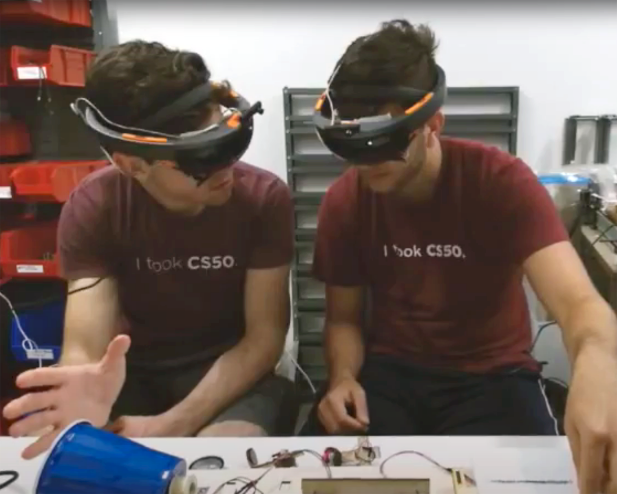 two students using AR headsets