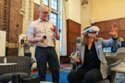 A faculty member experiences an XR demo wearing a VR headset at the 2022 XR@Michigan Summit