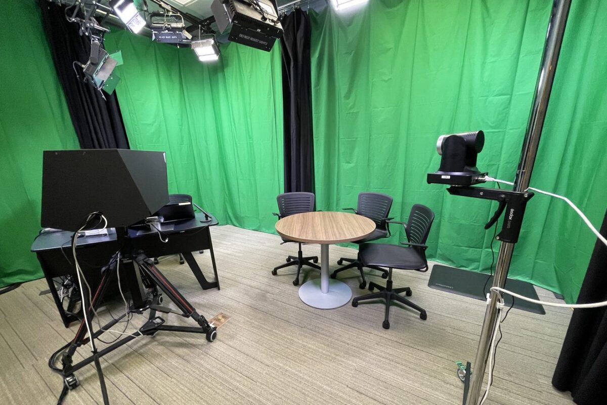 Personal studio with green screen, table and cameras.