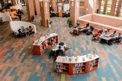 a view looking down into the Duderstadt Center 2nd Floor mezzanine reading area from the 3rd Floor balcony
