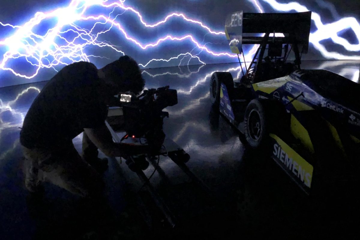 Sean Phelan films the launch video for the College of Engineering's Michigan Electric Racing MER20 vehicle "