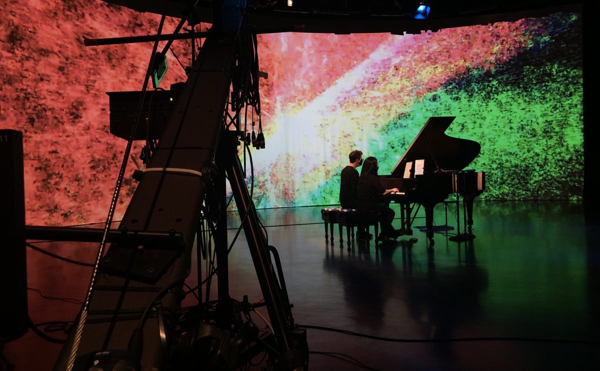 Melissa Coppola, a DMA candidate in the School of Music, Theatre, and Dance (SOMTD) Playing on the Steinway grand piano, recently installed in the Video Studio.