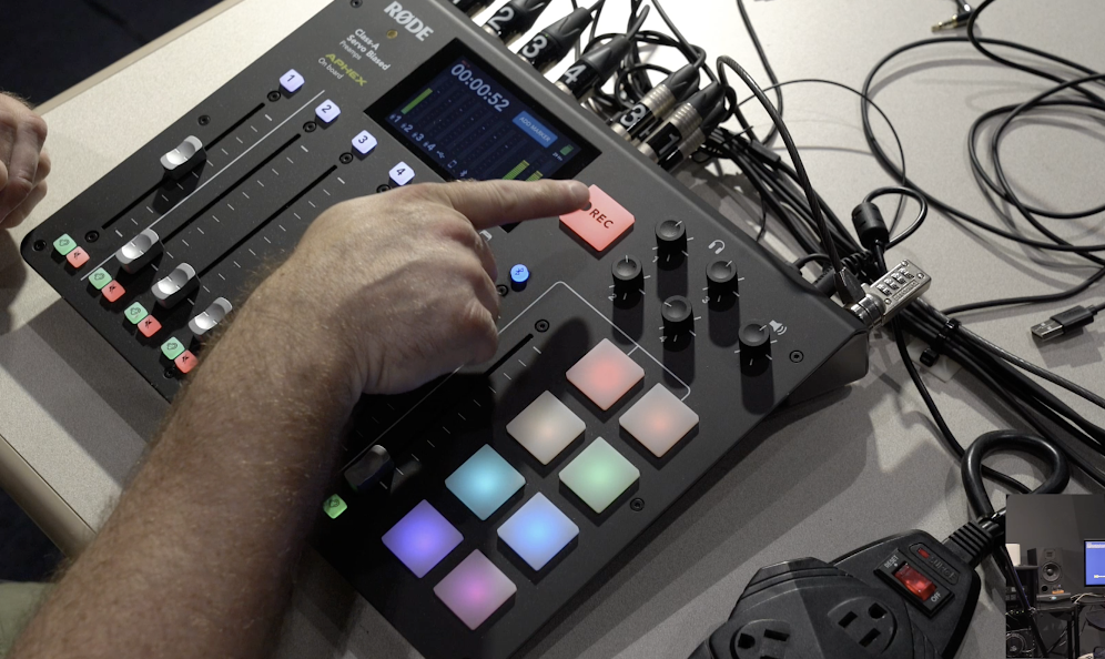Close up of a man operating Rodecaster pro in multimedia room