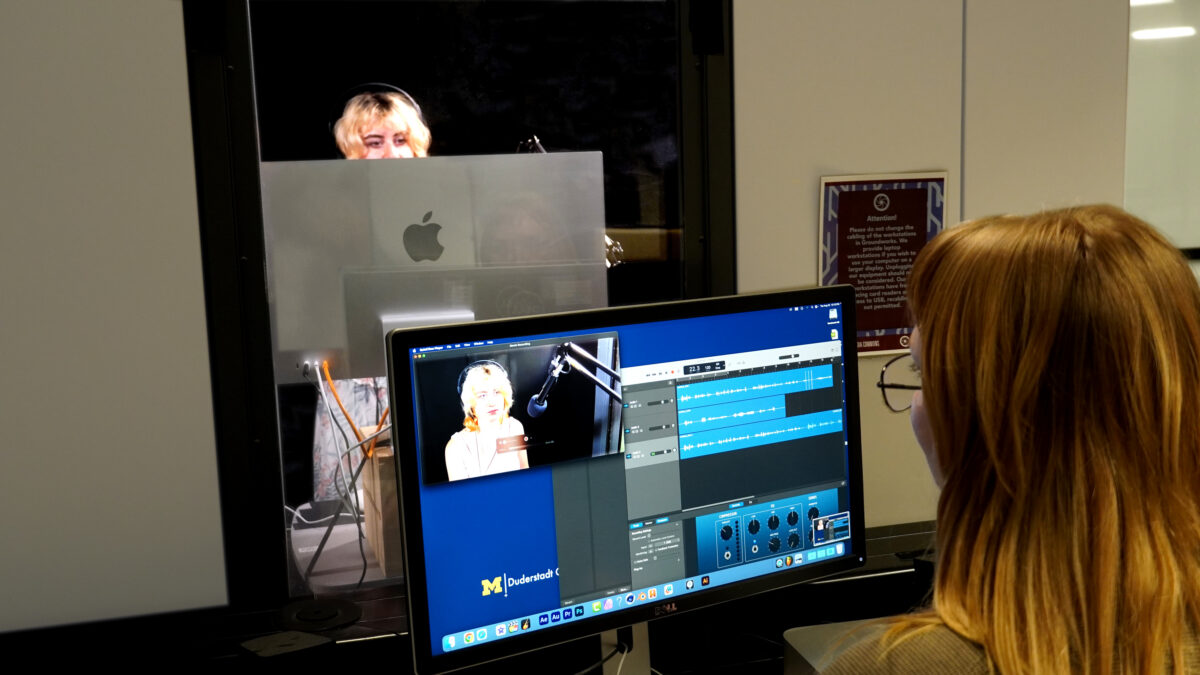 Recording booth in Groundworks where a student staff is sitting behind the laptop