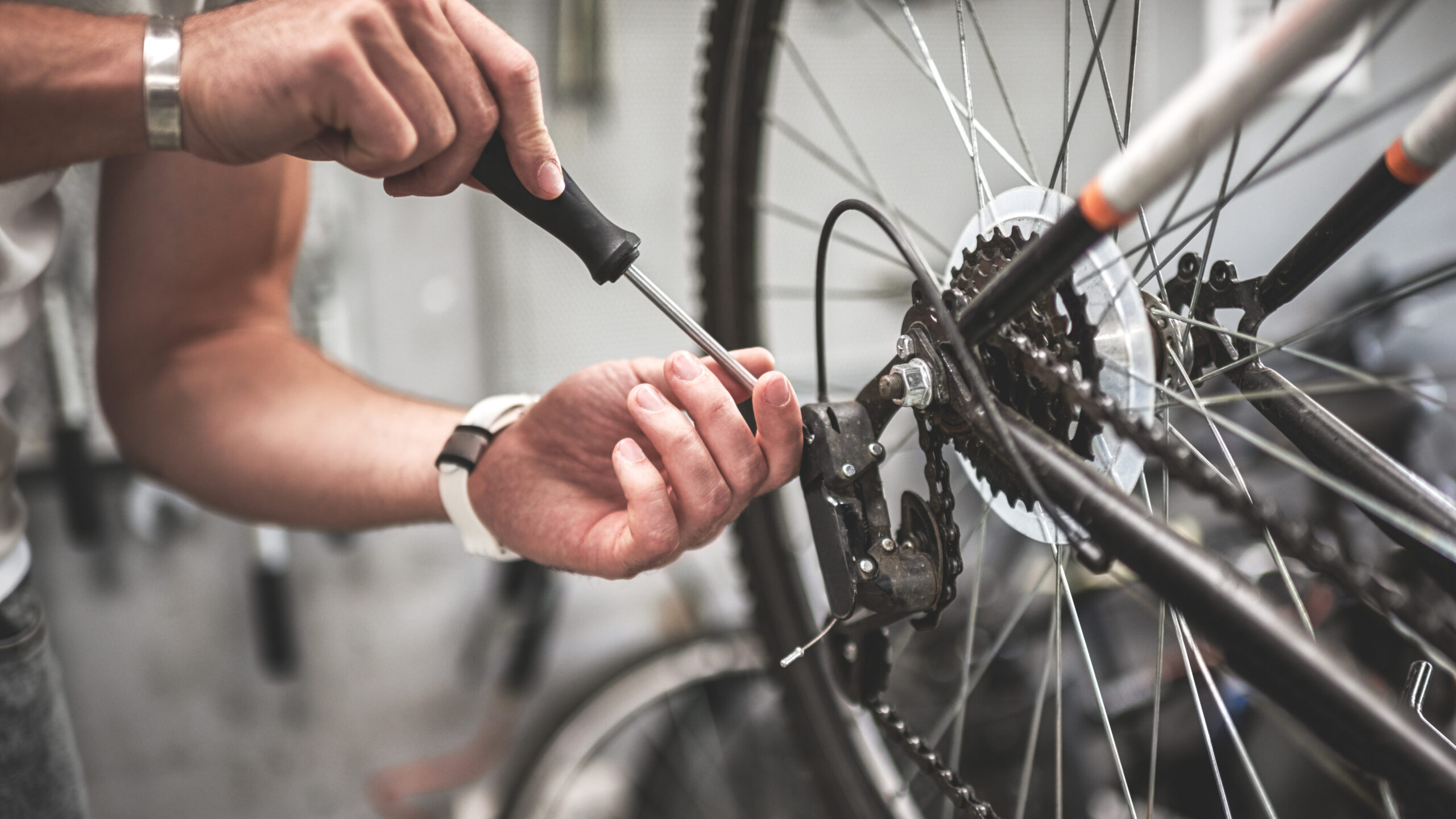 close up of hands fixing the bike wheel