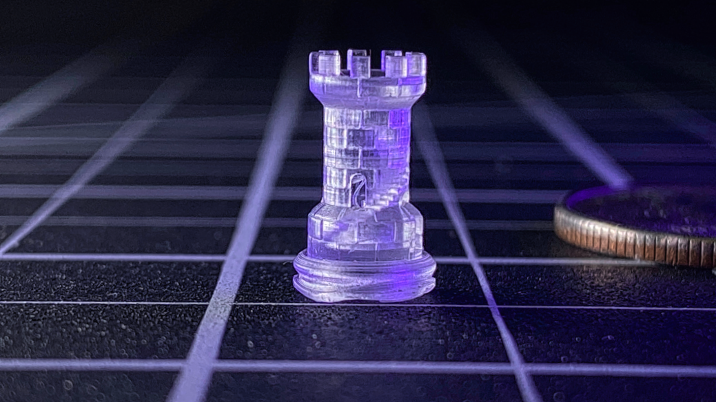 a miniature castle tower, complete with an interior staircase, less than 1" tall, printed in 3D on the Asiga Max X 3D printer (a U.S. Quarter coin shown for scale)