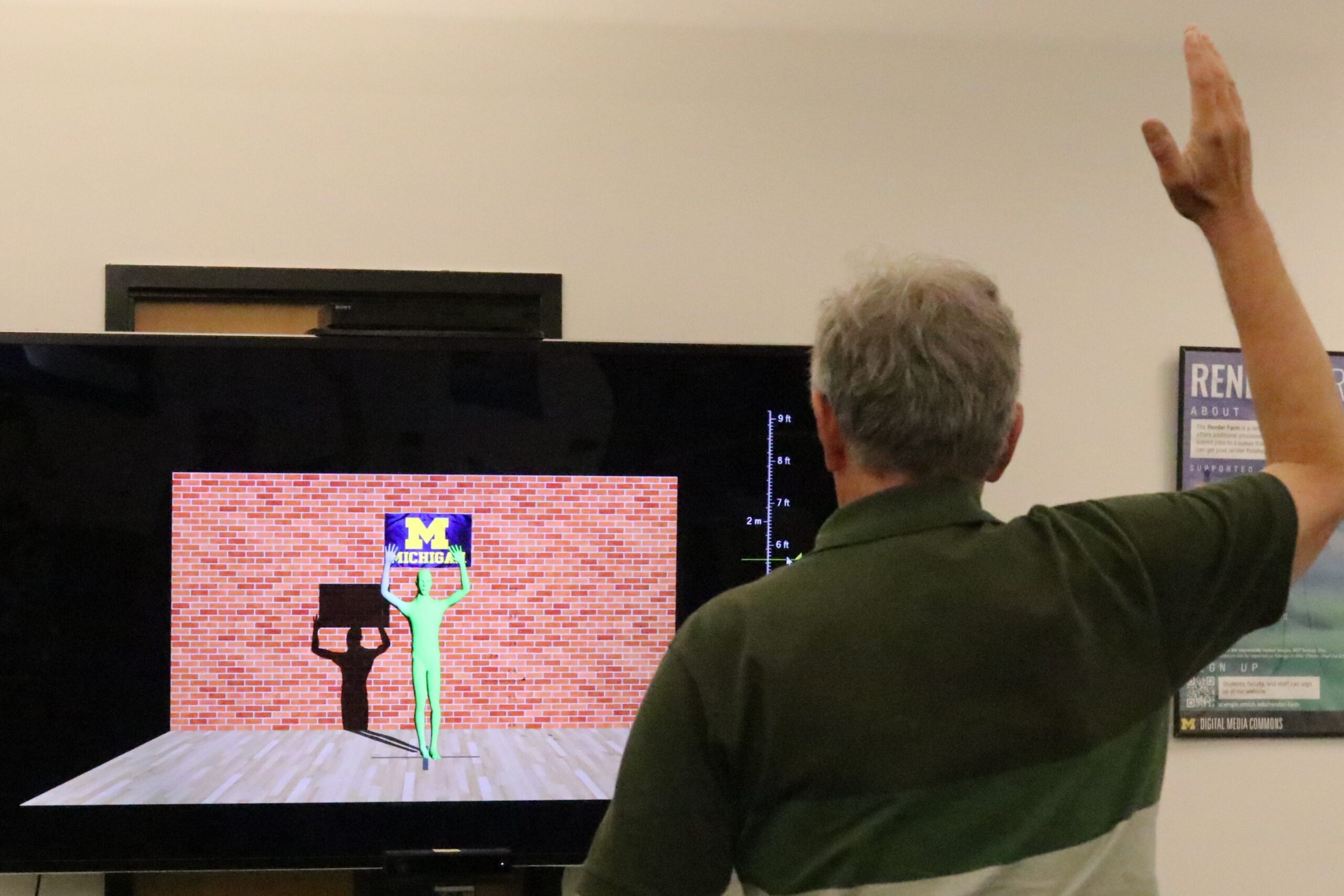 Ted raising his right hand in front of the screen to test the real-time interaction