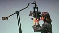 A person looking into a binocular display.