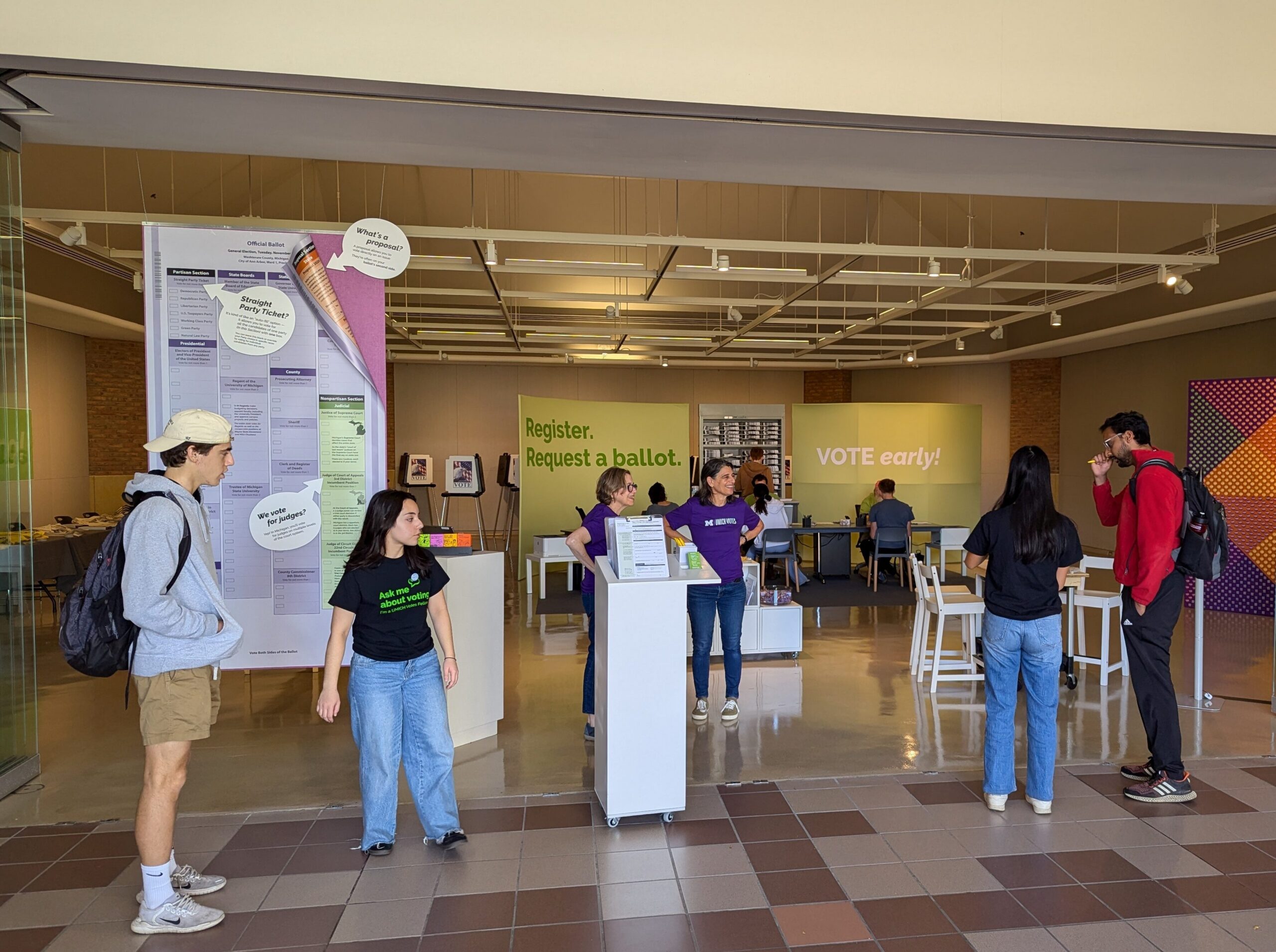 Students and volunteers at the Duderstadt Center voting hub